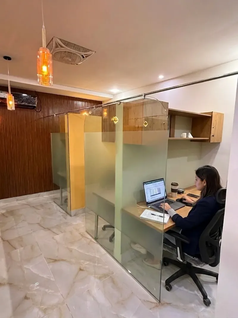 A member working at a dedicated desk at The Cowork, Lahore